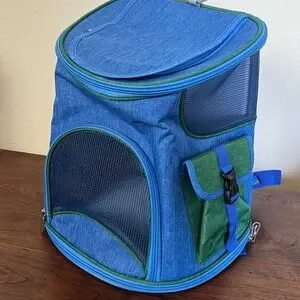 Small animal carrier with several pockets and breathing spaces